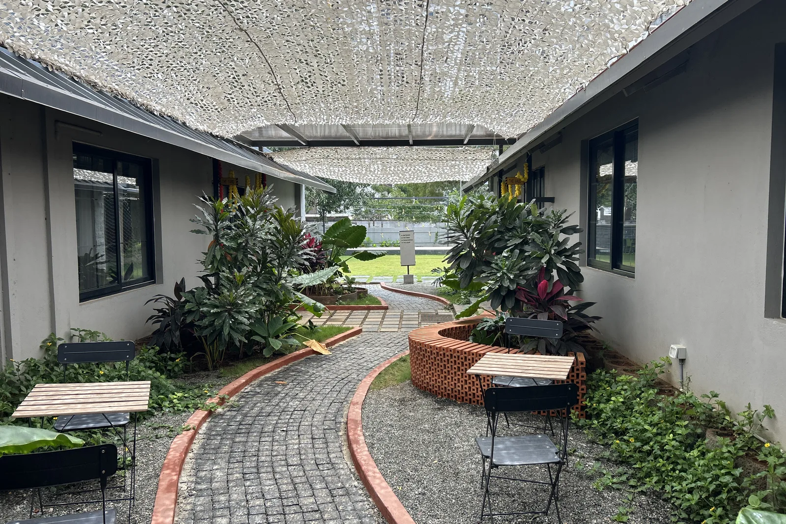 Landscaped courtyard and outdoor seating at the FERRASTACK workspace