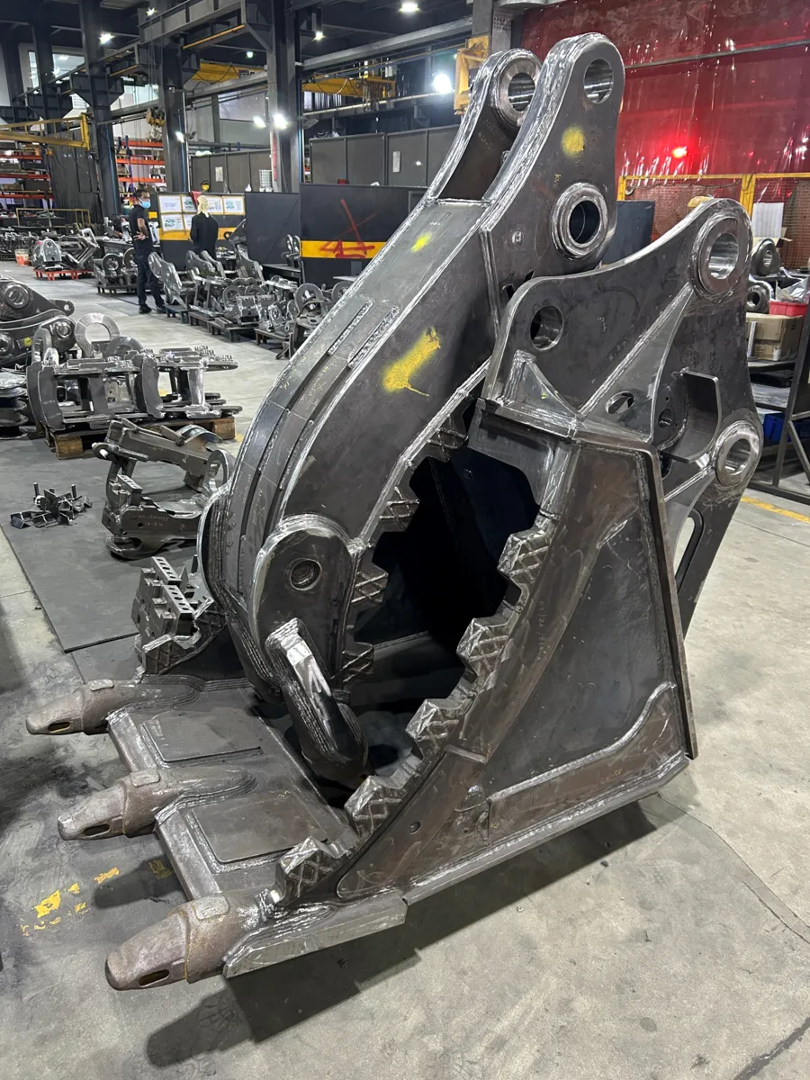 Large welded heavy-equipment attachment on a partner fabrication floor